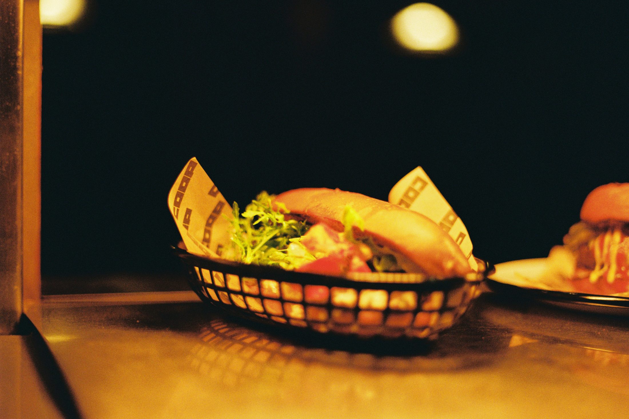 A fried chicken roll in a wire basket, COOP
